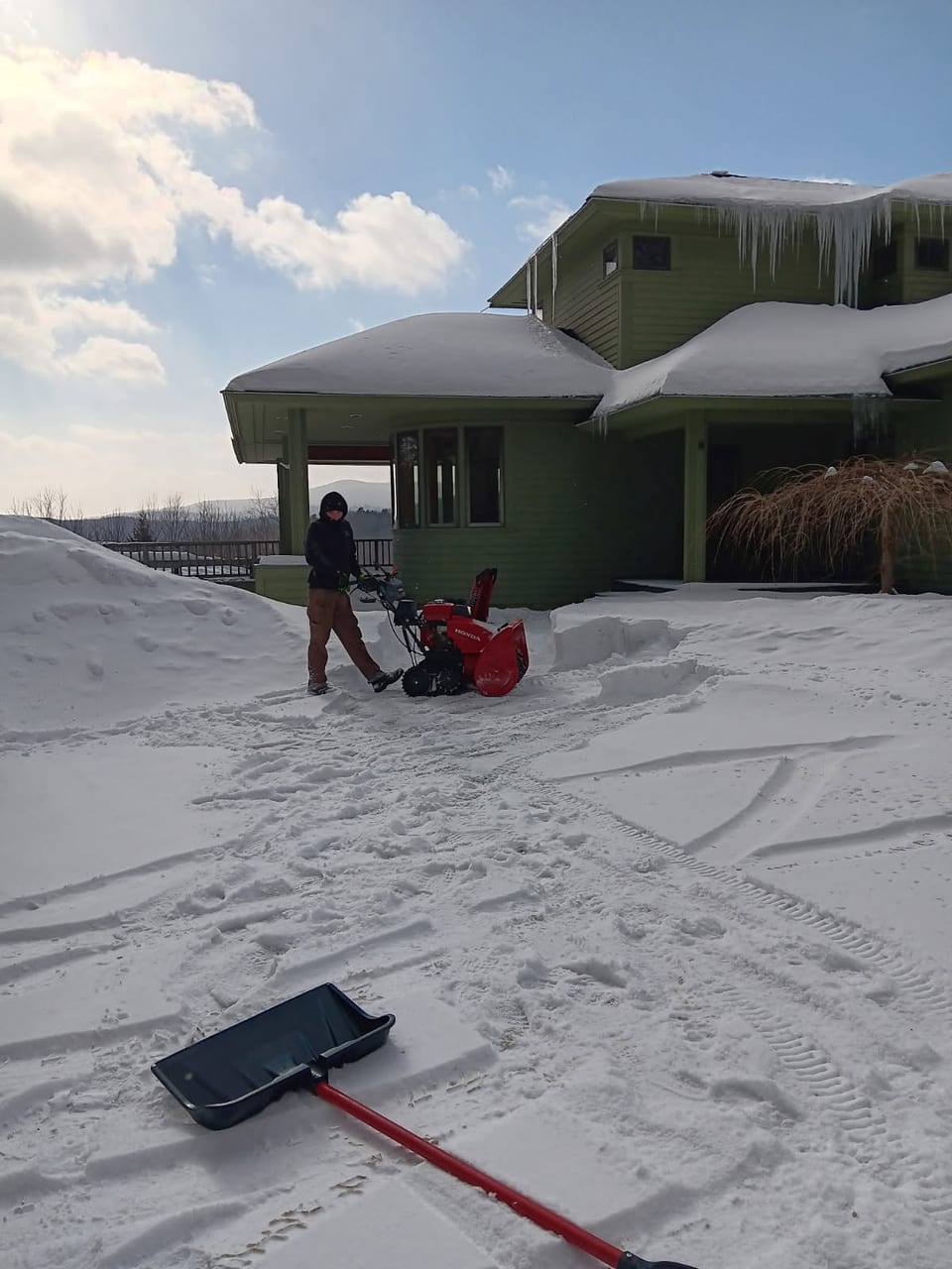 Snow blowing a mountain driveway to the door